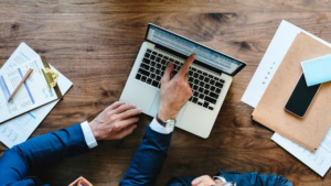 Australia mortgage broker pointing to loan form on laptop screen